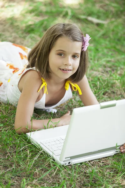 Child with laptop at park. — Stock Photo, Image