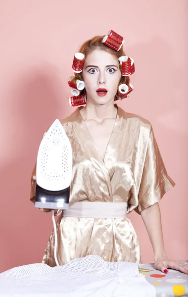 Housewife with iron and curler — Stock Photo, Image