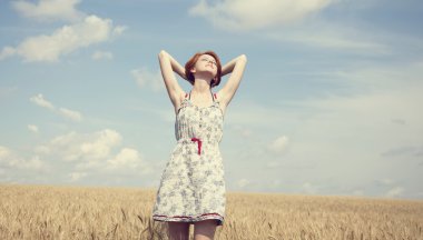 Young beautiful girl at wheat field. clipart