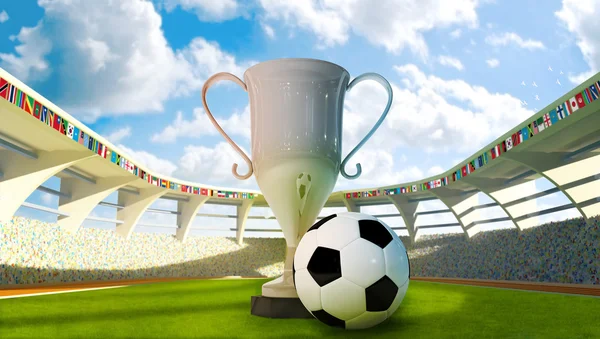 Кубок и футбольный мяч на стадионе — стоковое фото