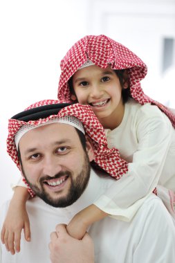 Adult and child with middle eastern clothes clipart