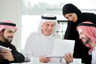 Successful and happy business arabic sitting for a meeting clipart