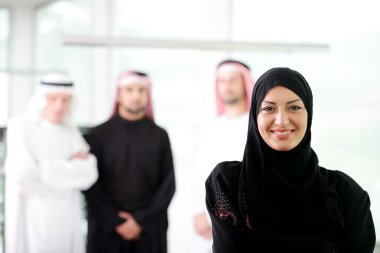 Arabic business woman working in team with her colleagues at office clipart