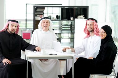 Arabic elderly business with his team at office clipart