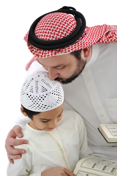 Middle eastern education, father kissing son while reading Koran — Stock Photo, Image