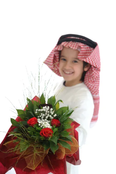 Cute arabic little boy with bouquet of flowers — Stock Photo, Image