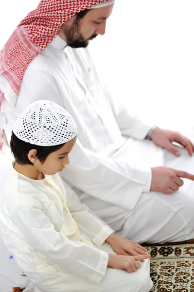 Muslim father and son praying together Royalty Free Stock Images
