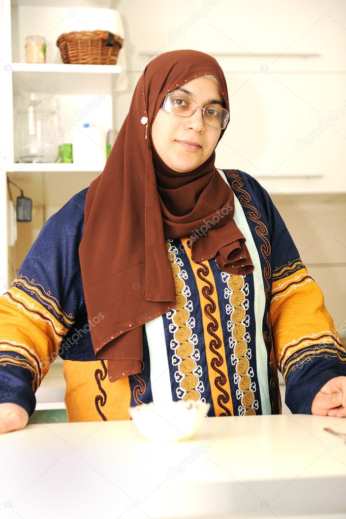 Beautiful muslim woman in the kitchen