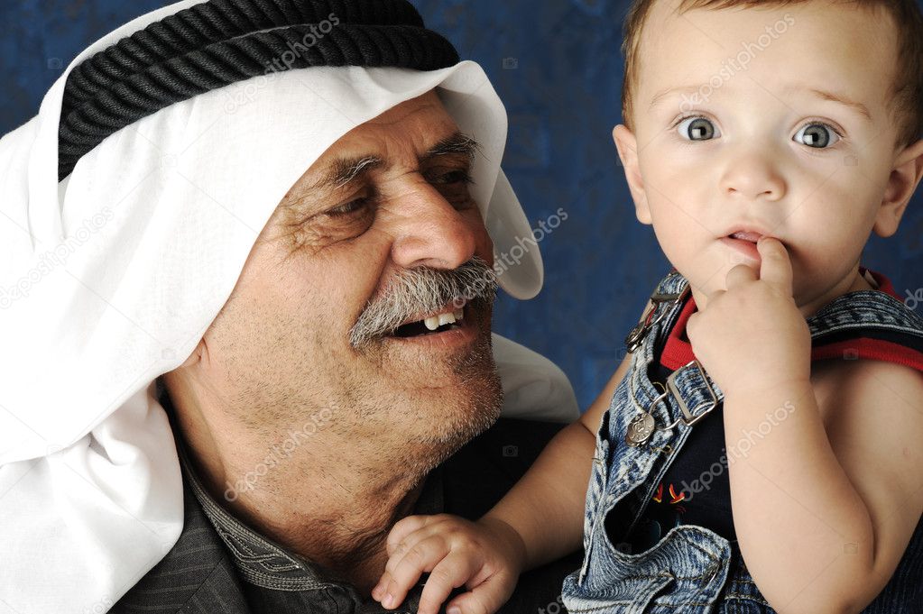 Adult man holding a young baby