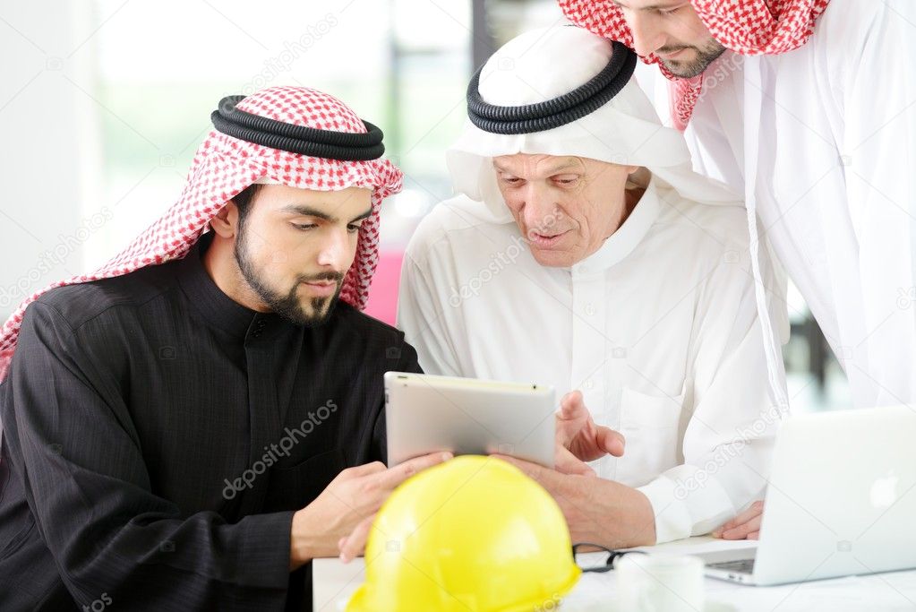 Successful and happy business arabic sitting for a meeting