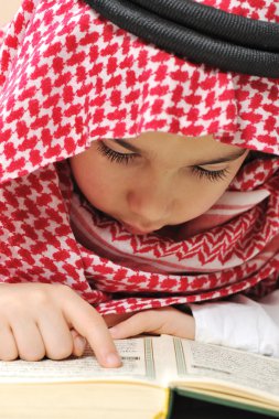 Muslim child with Koran clipart