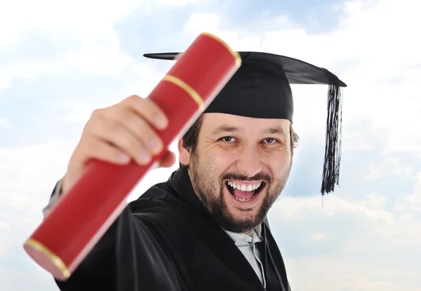 Podekscytowany absolwent w sukni — Zdjęcie stockowe