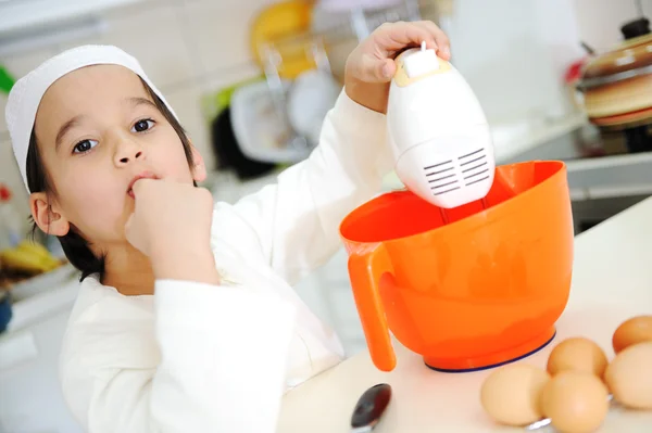 Little kid boy is cooking — Stock Photo, Image