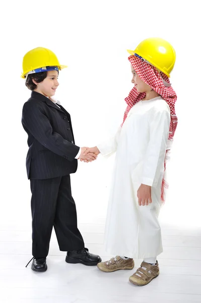 Caucasian and middle eastern little architects handshaking — Stock Photo, Image