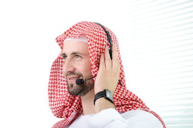 Portrait of a smart arabic business man using headset. Call center. Customer support. Helpdesk. clipart