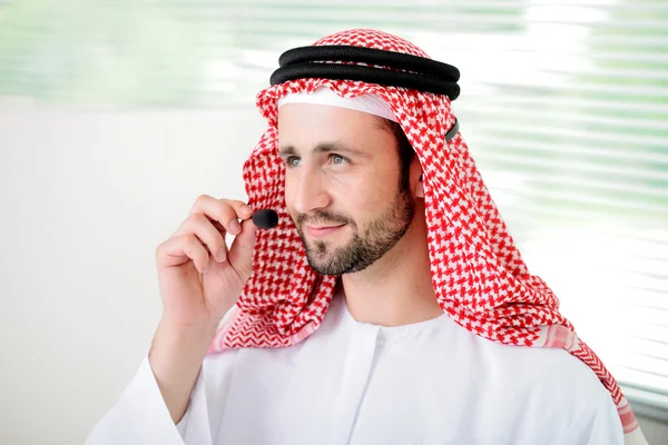 Porträtt av en smart arabiska affärsman använder headset. Ring cen — Stockfoto