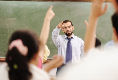 Arabic kids in the school, classroom wit a teacher clipart