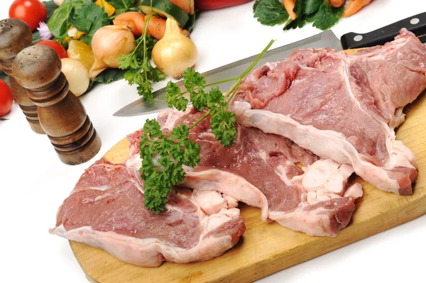 Carne fresca cruda tagliata a cubetti a bordo con verdure — Foto Stock