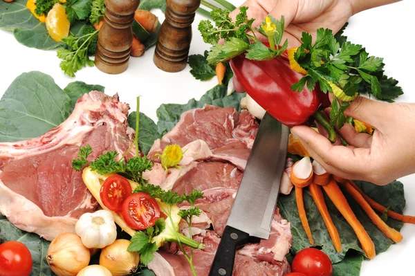 Sliced fresh raw meat on board with vegetables — Stock Photo, Image