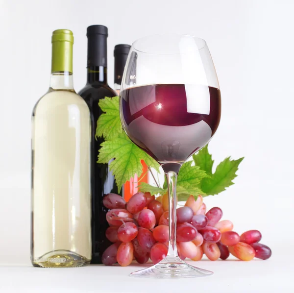 Sklo, láhve vína a hroznů — Stock fotografie