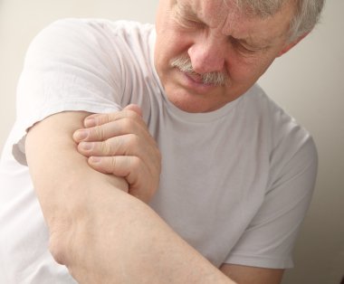 Senior man with arm pain clipart