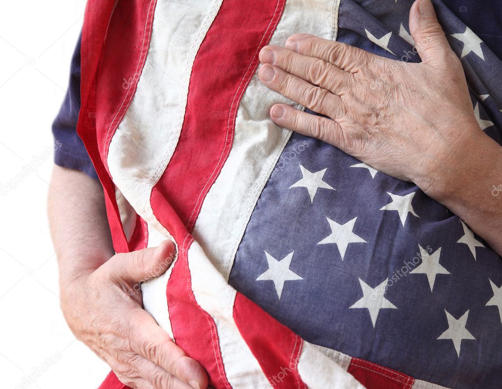 Man holds American flag close to his body