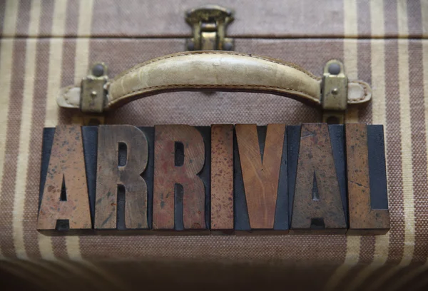 Arrival word on old luggage — Stock Photo, Image
