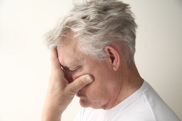 Man with hand over face