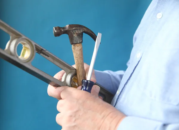 Værktøjer i en mands hånd - Stock-foto