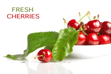 Fresh cherry berries with green leaves isolated on white clipart