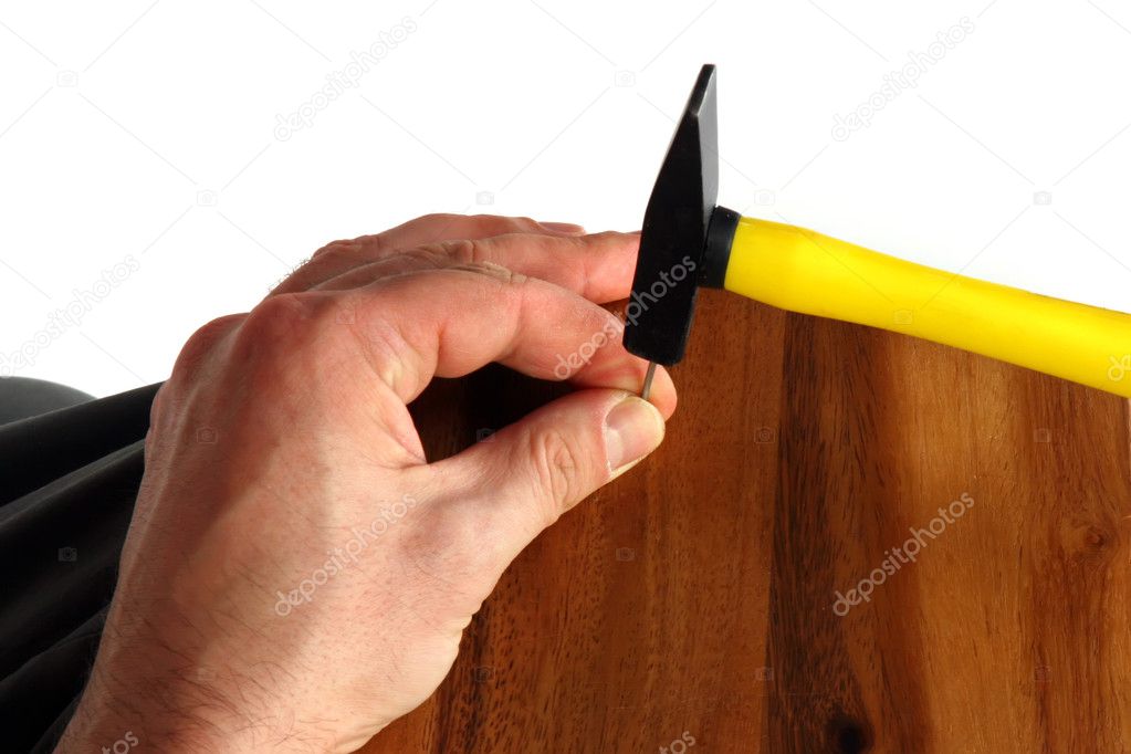 Hand with hammer and nail