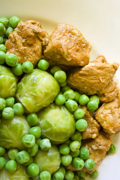 stock image Fresh stew of beef and pork with green peas and Brussels sprout