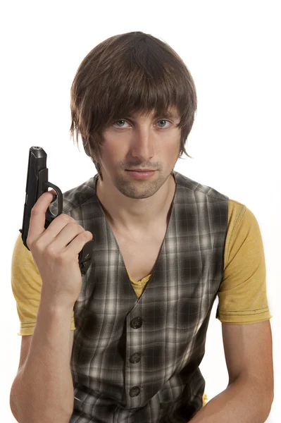 A young man with a gun in his hand — Stock Photo, Image