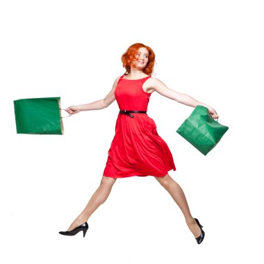 Readhead with green shopping bags jumping clipart