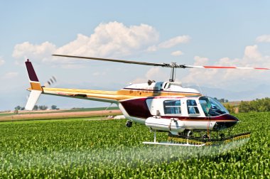 Crop Duster Spraying a Field clipart