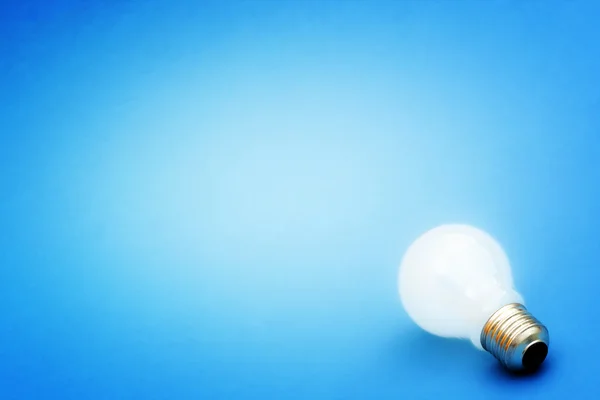 Background with lit lightbulb — Stock Photo, Image