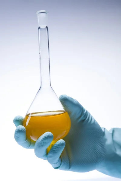 stock image Scientist working in a laboratory , glass containing liquid color