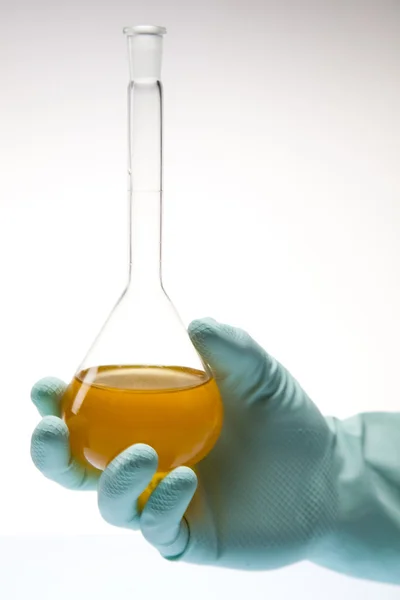 stock image Scientist working in a laboratory , glass containing liquid color