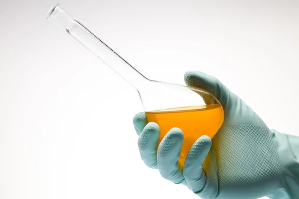 stock image Scientist working in a laboratory , glass containing liquid color