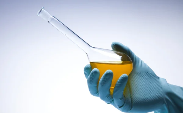 stock image Scientist working in a laboratory , glass containing liquid color