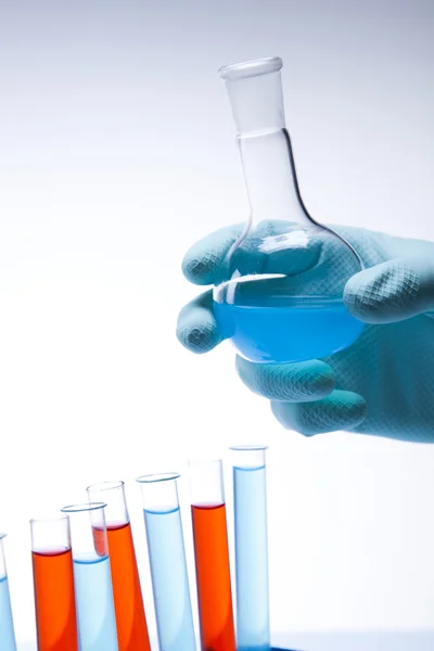 Επιστήμονας που εργάζεται σε εργαστήριο, ποτήρι που περιέχει υγρό χρώμα — Φωτογραφία Αρχείου