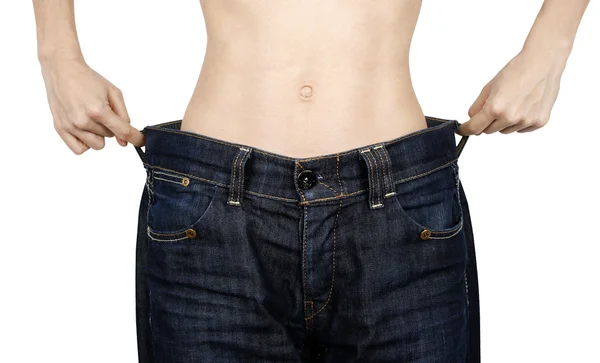 Slanke vrouw in grote jeans — Stockfoto
