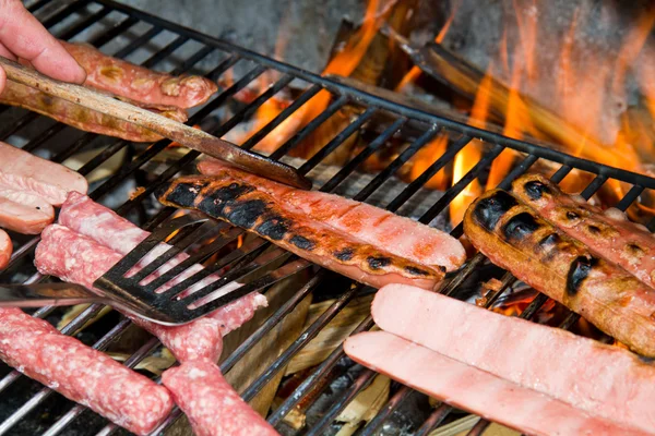Brats cooking on the grill — Stock Photo, Image