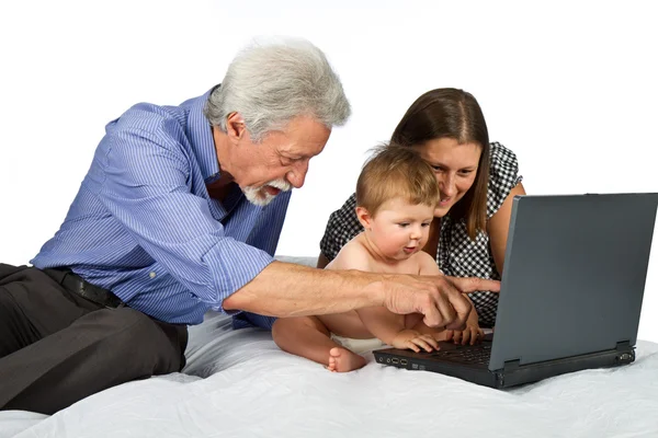 Moeder en grootvader met baby spelen met pc — Stockfoto