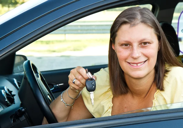 Auto bestuurder vrouw die lacht nieuwe autosleutels weergegeven: — Stockfoto