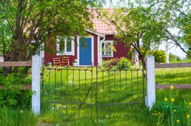 Entrance of red wooden cottage in Sweden clipart