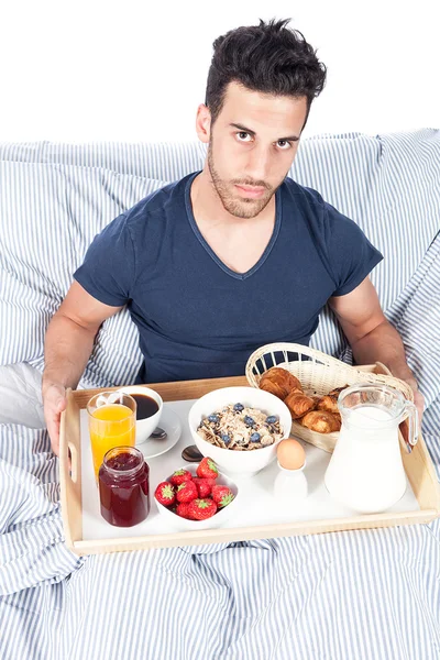 男はベッドで朝食を持っています。 — ストック写真