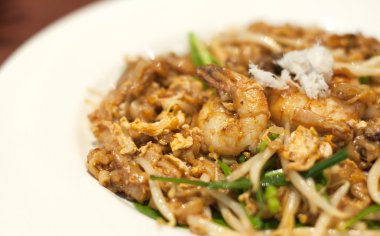 Fried Penang Char Kuey Teow which is a popular noodle dish in Ma clipart