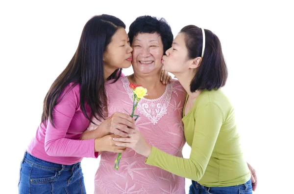 Daughters kissing to her mum. — Stock Photo, Image
