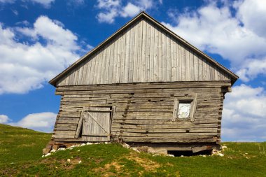 Wooden house and mountains clipart